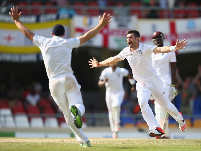 James Anderson of England claims the wicket of Denesh Ramdin of West Indies to pass Ian Botham's record of 383 Test wickets and become England's highest Test wicket bowler during day five of the 1st Test match between West Indies and England at the Sir Vi