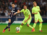 Javier Pastore of PSG is challenged by Sergio Busquets of Barcelona during the UEFA Champions League Quarter Final First Leg match between Paris Saint-Germain and FC Barcelona at Parc des Princes on April 15, 2015