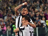 Juventus' forward from Argentina Carlos Tevez celebrates after scoring with Juventus' midfielder from Chile Arturo Vidal during the Italian Serie A football match Juventus vs Lazio at 'Juventus Stadium' in Turin on April 18, 2015