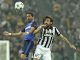 Joao Moutinho of AS Monaco FC competes for the ball with Andrea Pirlo of Juventus FC during the UEFA Champions League Quarter Final First Leg match between Juventus and AS Monaco FC at Juventus Arena on April 14, 2015 