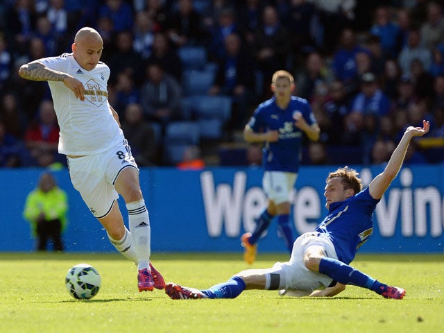 Marc Albrighton of Leicester City tackles Jonjo Shelvey of Swansea during the Barclays Premier League match between Leicester City and Swansea City at The King Power Stadium on April 18, 2015