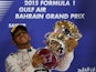 Mercedes AMG Petronas British driver Lewis Hamilton celebrates with his trophy on the podium after winning the Formula One Bahrain Grand Prix at the Sakhir circuit in the desert south of the Bahraini capital, Manama, on April 19, 2015