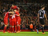 Joe Allen of Liverpool celerbates with team mates as he scores their second goal during the Barclays Premier League match between Liverpool and Newcastle United at Anfield on April 13, 2015