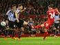 Joe Allen of Liverpool shoots past Michael Williamson of Newcastle United to score their second goal during the Barclays Premier League match between Liverpool and Newcastle United at Anfield on April 13, 2015
