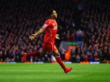 Raheem Sterling of Liverpool celebrates as he scores their first goal during the Barclays Premier League match between Liverpool and Newcastle United at Anfield on April 13, 2015