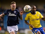 Aiden O'Brien of Millwall FC and Emmerson Boyce of Wigan Athletic during the Sky Bet Championship match between Millwall and Wigan Athletic at The Den on April 14, 2015