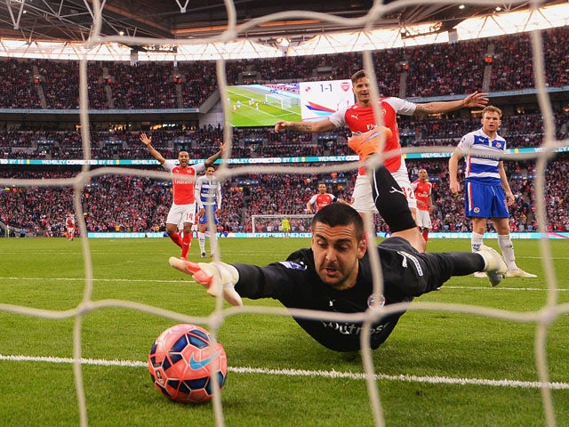 Adam Federici of Reading stretches for the ball as he fails to stop a shot by Alexis Sanchez of Arsenal for their second goal during the FA Cup Semi Final between Arsenal and Reading at Wembley Stadium on April 18, 2015