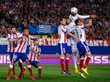 Raphael Varane and Sergio Ramos of Real Madrid CF and Mario Mandzukic and Diego Godín of Atletico Madrid compete for the header during the UEFA Champions League Quarter Final First Leg match between Club Atletico de Madrid and Real Madrid CF at Vicente
