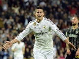Real Madrid's Colombian midfielder James Rodriguez celebrates after scoring during the Spanish league football match Real Madrid CF vs Malaga FC at the Santiago Bernabeu stadium in Madrid on April 18, 2015