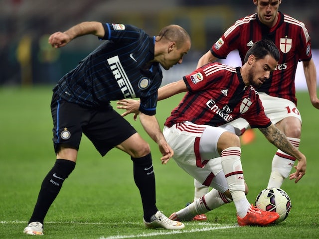 AC Milan's midfielder from Spain Suso (R) fights for the ball with Inter Milan's forward from Argentina Rodrigo Palacio (L) during the Italian Serie A football match Inter Milan vs AC Milan at the San Siro Stadium in Milan on April 19, 2015