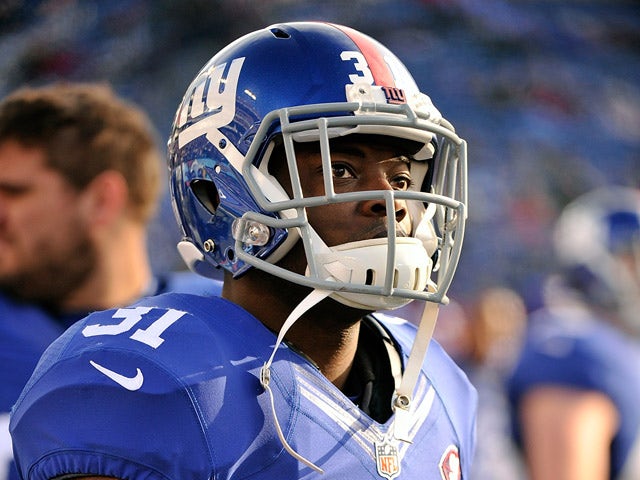 Zack Bowman #31 of the New York Giants watches from the sideline during the second half of a game against the Tennessee Titans at LP Field on December 7, 2014