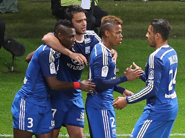 Lyon's forward Clinton Mua Njie (2nd L) celebrates with teammates after scoring a goal during the French Football match between Reims and Lyon on April 26, 2015