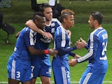Lyon's forward Clinton Mua Njie (2nd L) celebrates with teammates after scoring a goal during the French Football match between Reims and Lyon on April 26, 2015