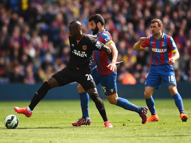 Dame N'Doye of Hull City is challenged by Mile Jedinak of Crystal Palace during the Barclays Premier League match between Crystal Palace and Hull City at Selhurst Park on April 25, 2015