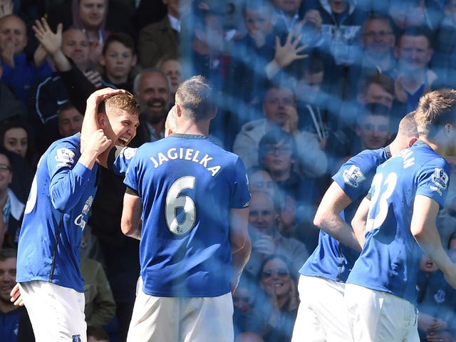 Everton's English defender John Stones celebrates with teammates after scoring their secong doal during the English Premier League football match between Everton and Manchester United at Goodison park in Liverpool on April 26, 2015
