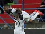 Guingamp's French midfielder Claudio Beauvue is congratulated by a teammate after scoring a goal during the French L1 football match between Caen and Guingamp on April 25, 2015