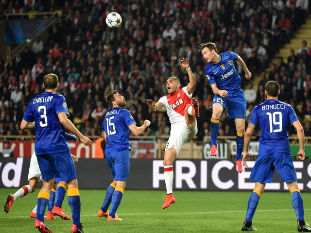 Juventus' defender from Switzerland Stephan Lichtsteiner and Monaco's French defender Layvin Kurzawa go for a header during the UEFA Champions League quarter final second leg football match AS Monaco vs Juventus FC on April 22, 2015