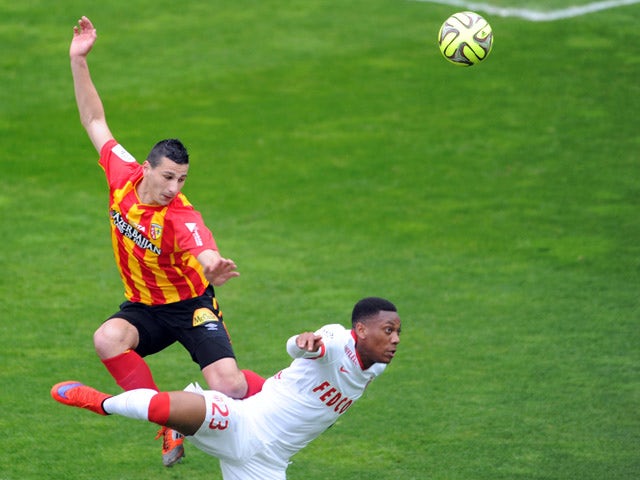 Lens' French forward Yoann Touzghar vies with Monaco's French forward Anthony Martial during the French L1 football match between Lens and Monaco at Licorne stadium in Amiens, northern France, on April 26, 2015