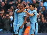 Fernandinho of Manchester City celebrates his winning goal with Martin Demichelis (L) and Jesus Navas of Manchester City during the Barclays Premier League match between Manchester City and Aston Villa at Etihad Stadium on April 25, 2015