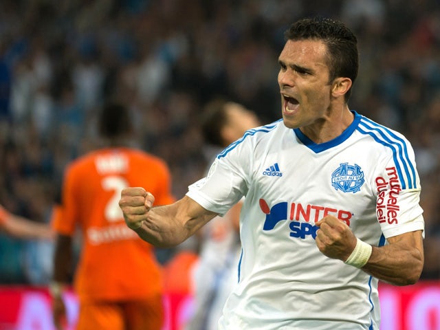 Marseille's French defender Jeremy Morel celebrates after scoring a goal during the French L1 football match between Marseille and Lorient on April 24, 2015