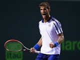Martin Klizan of Slovakia celebrates a point against Novak Djokovic of Serbiain their second round match during the Miami Open Presented by Itau at Crandon Park Tennis Center on March 28, 2015