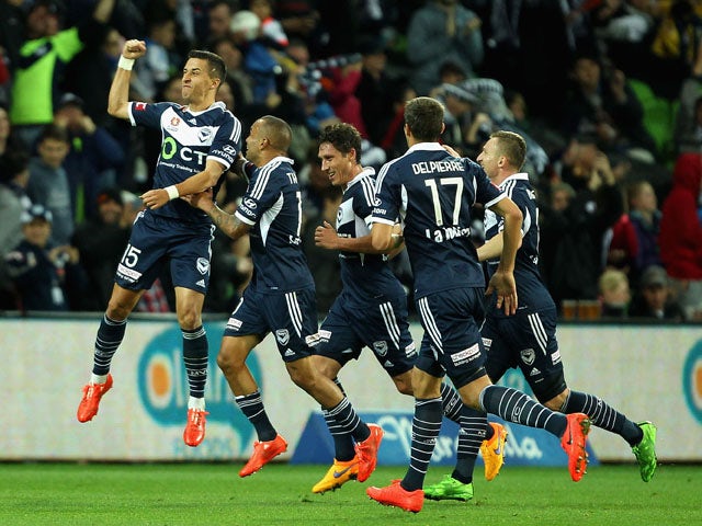 Daniel Georgievski of Melbourne celebrates with team-mates after scoring a goal during the round 27 A-League match between the Melbourne Victory and Central Coast Mariners at AAMI Park on April 26, 2015