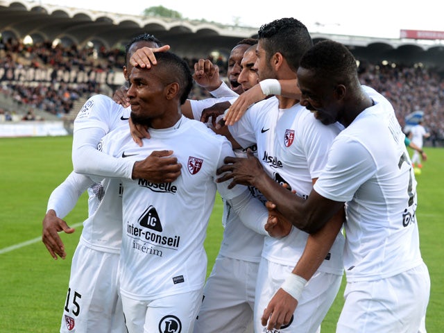 Metz's players celebrate after their Tunisian midfielder Ferjani Sassi scored a goal during the French L1 football match between Bordeaux (FCGB) and Metz (FCM) on April 25, 2015