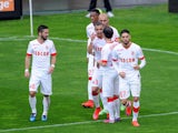 Monaco's Belgian midfielder Yannick Ferreira Carrasco celebrates with teammates after scoring a goal during the French L1 football match between Lens and Monaco at Licorne stadium in Amiens, northern France, on April 26, 2015