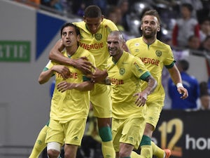 Nantes' US midfielder Alejandro Bedoya celebrates with teammates after scoring a goal during the French L1 football match between Toulouse and Nantes at the Municipal Stadium in Toulouse on April 25, 2015