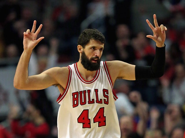 Nikola Mirotic #44 of the Chicago Bulls holds up his fingers after hitting a three point shot against the Toronto Raptors at the United Center on March 20, 2015
