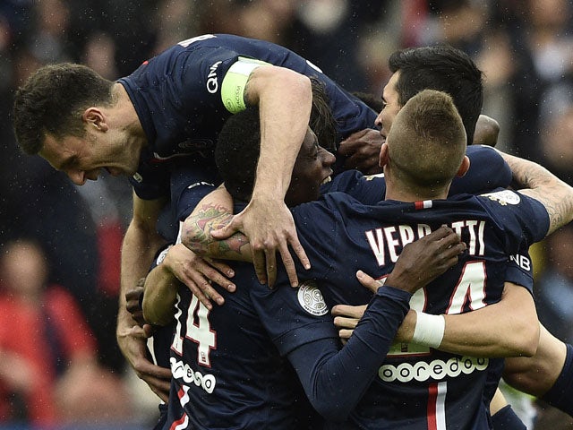 Paris Saint-Germain's Brazilian defender Maxwell is congratuled by teammates after scoring a goal during the French L1 football match between Paris Saint-Germain and Lille on April 25, 2015
