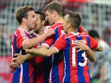 Bayern Munich's midfielder Thomas Mueller (2nd R) celebrates scoring with his team-mates during the UEFA Champions League second-leg quarter-final football match Bayern Munich v FC Porto in Munich, southern Germany on April 21, 2015