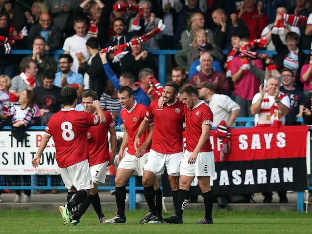 Tom Greaves of FC United Of Manchester is congratulated by his team-mates after scoring the opening goal during the FA Cup Qualifying First Round match between FC United Of Manchester and Prescot Cables on September 14, 2014