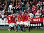 Tom Greaves of FC United Of Manchester is congratulated by his team-mates after scoring the opening goal during the FA Cup Qualifying First Round match between FC United Of Manchester and Prescot Cables on September 14, 2014