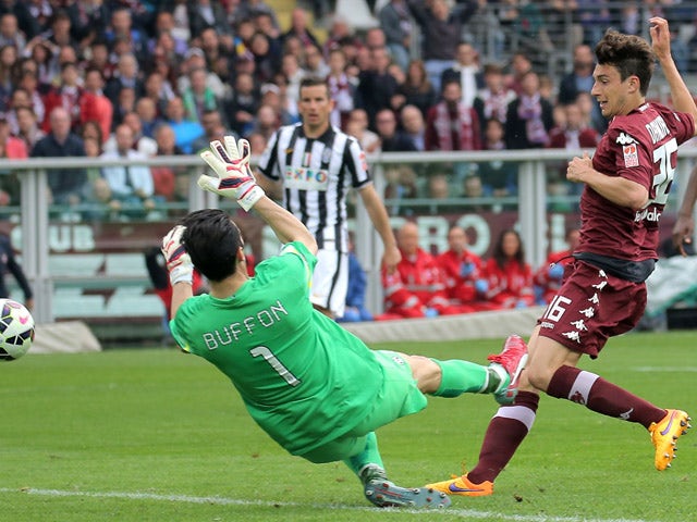 Torino's defender Matteo Darmian scores past Juventus' goalkpeeper Gianluigi Buffon during the Italian Serie A football match Torino vs Juventus on April 26, 2015 