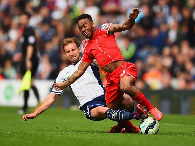 Craig Dawson of West Brom tackles Raheem Sterling of Liverpool during the Barclays Premier League match between West Bromwich Albion and Liverpool at The Hawthorns on April 25, 2015