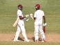 West Indies batsmen Kraigg Brathwaite and Darren Bravo confer during day four of the second Test cricket match between the West Indies and England at the Grenada National Stadium in Saint George's on April 24, 2015