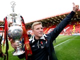 Eddie Howe, manager of Bournemouth celebrates with the trophy after winning the Championship during the Sky Bet Championship match between Charlton Athletic and AFC Bournemouth at The Valley on May 2, 2015