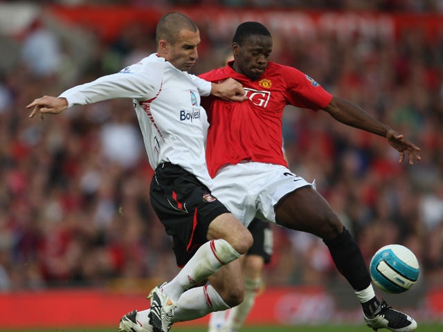 Louis Saha of Manchester United battles for the ball with Danny Higginbotham of Sunderland during the Barclays Premier League match between Manchester United and Sunderland at Old Trafford on September 1, 2007