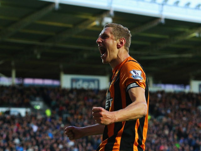 Michael Dawson of Hull City celebrates as he scores their first goal during the Barclays Premier League match between Hull City and Liverpool at KC Stadium on April 28, 2015