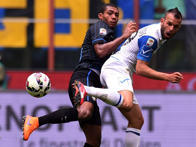 Juan Jesus of Internazionale Milano and Riccardo Meggiorini of Chievo Verona compete for the ball during the Serie A match between FC Internazionale Milano and AC Chievo Verona at Stadio Giuseppe Meazza on May 3, 2015