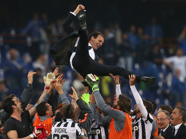Juventus' players celebrate with their coach Massimiliano Allegri after winning the 'Scudetto' at the end of the Italian Serie A football match Sampdoria Vs Juventus on May 2, 2015