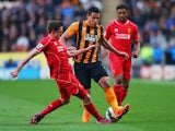 Jake Livermore of Hull City takes on Joe Allen and Jordon Ibe of Liverpool during the Barclays Premier League match between Hull City and Liverpool at KC Stadium on April 28, 2015