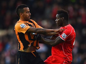 Tom Huddlestone of Hull City and Mario Balotelli of Liverpool clash during the Barclays Premier League match between Hull City and Liverpool at KC Stadium on April 28, 2015