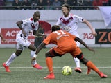 Bordeaux's Uruguyan forward Diego Rolan, Bordeaux's Czech midfielder Jaroslav Plasil and Lorient's Gabonese midielder Ndong Ibrahim Didier (C) play the ball during the French L1 football match between FC Lorient and FC Girondins de Bordeaux on May 2, 2015