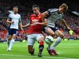 Robin van Persie of Manchester United tangles with Craig Dawson of West Brom during the Barclays Premier League match between Manchester United and West Bromwich Albion at Old Trafford on May 2, 2015 