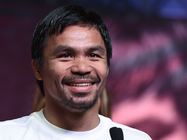 WBO welterweight champion Manny Pacquiao smiles during a fan rally at the Mandalay Bay Convention Center on April 28, 2015