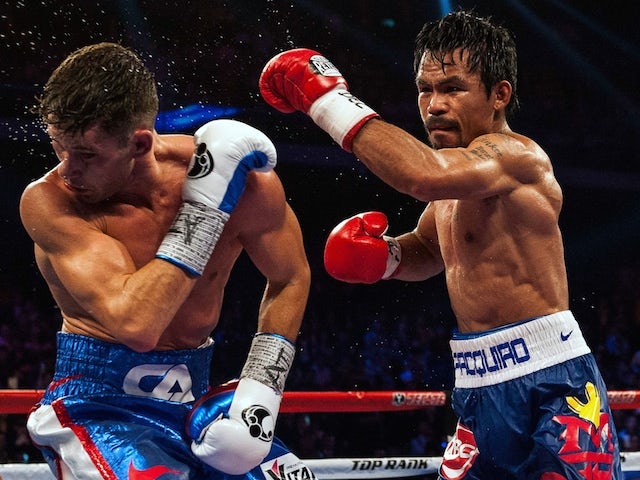 Manny Pacquiao of the Philippines (R) fights against Chris Algieri of the US during their World Boxing Organization welterweight title bout at the Cotai Arena in Macau on November 23, 2014