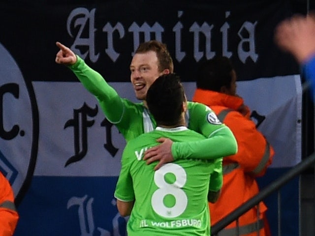 Wolfsburg's midfielder Maximilian Arnold and his teammate Portuguese striker Vieirinha (front) celebrate after scoring 0-1 during the German Cup DFB Pokal semi-final football match Bielefeld v Wolfsburg in Bielefeld, northern Germany, on April 29, 2015