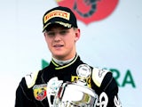 Mick Schumacher, son of former F1 champion Michael Schumacher, celebrates after winning the trophy for the best rookie after the first race of the ADAC Formula Four championship in Oschersleben, Germany, on April 25, 2015